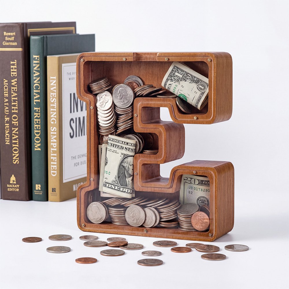 Close-up of large walnut wooden letter piggy bank with clear acrylic top, filled with coins and bills, large capacity storage