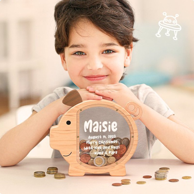 Personalized wooden pig shape piggy bank by Summidate, held by a smiling boy. A classic custom gift for kids in the USA.