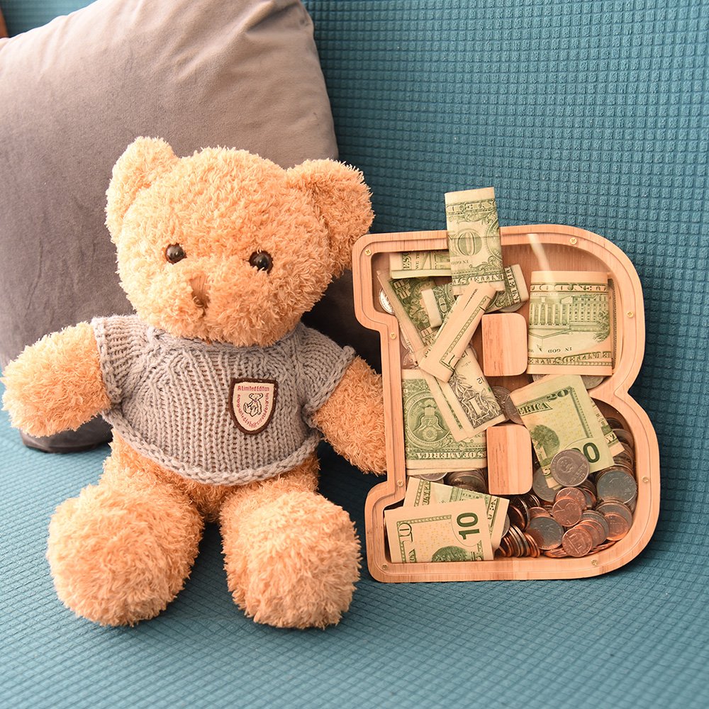 Personalized wooden letter B coin bank styled with a cute teddy bear, a perfect baby shower gift and beautiful nursery room decor in Canada.
