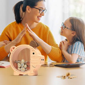 A mother and daughter happily counting coins together with their natural wood piggy bank on the desk. A great tool for teaching financial literacy and building family savings habits.