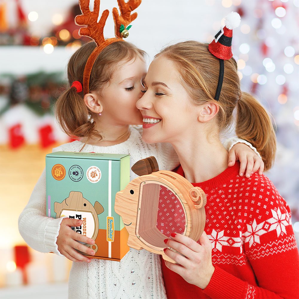 A mother and daughter sharing a happy moment during Christmas. The wooden piggy bank comes in a beautiful branded gift box, making it a perfect holiday present for children.