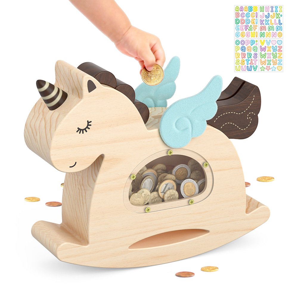 Natural wood rocking unicorn coin bank. A toddler's hand is dropping a coin into the top slot. Includes colorful alphabet stickers for fun DIY personalization.