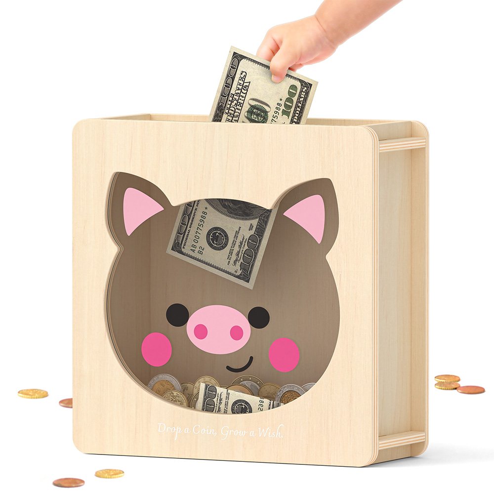 Dropping folded dollar bills into the top slot of a pink cute pig cash bank, perfect for little girls saving their allowance.