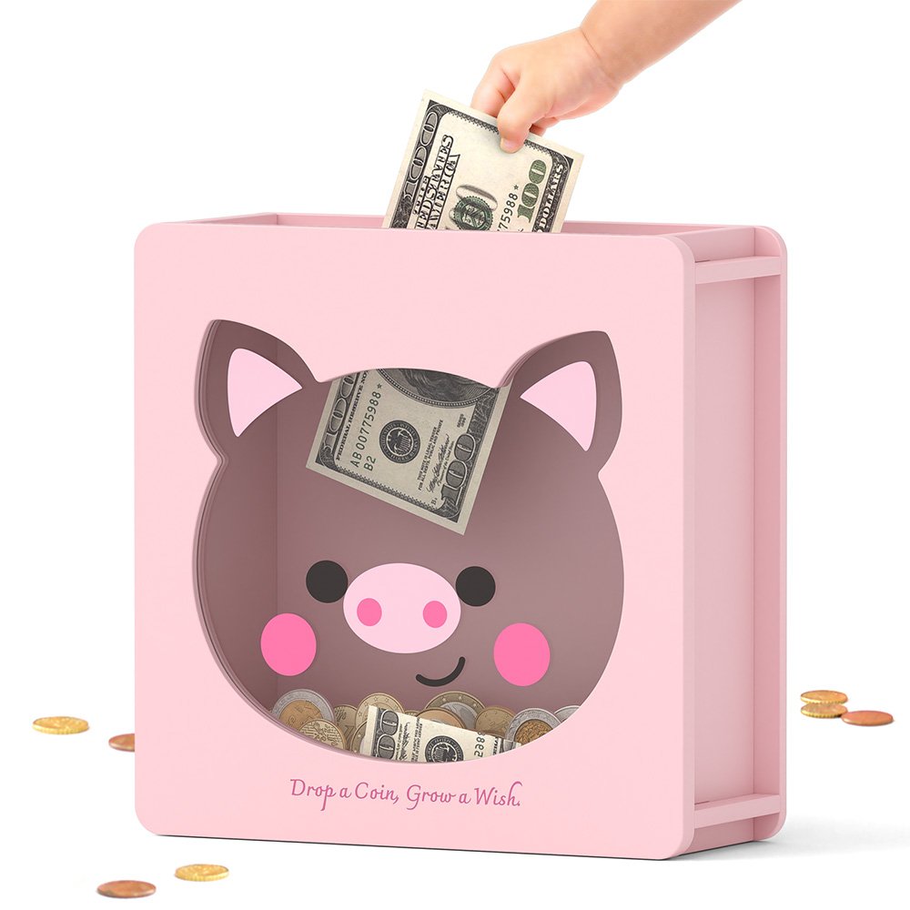 Dropping folded dollar bills into the top slot of a pink cute pig cash bank, perfect for little girls saving their allowance.