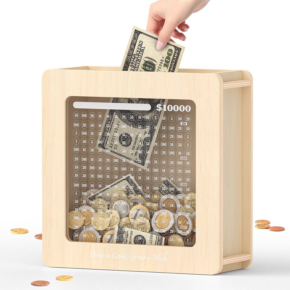 Inserting dollar bills into the natural wood savings goal coin bank, watching the money grow behind the clear printed tracking grid.