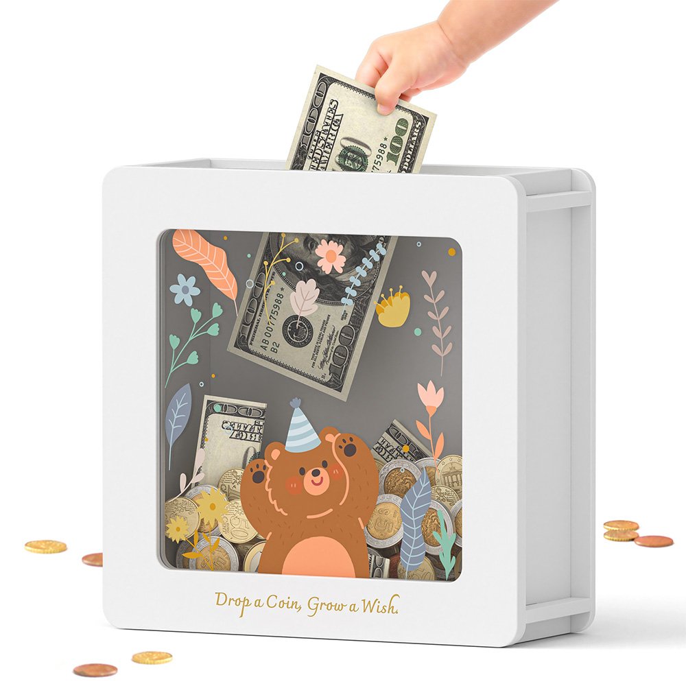Dropping folded paper money into the top slot of a white cute bear cash savings bank, a great way for kids to save their pocket money.