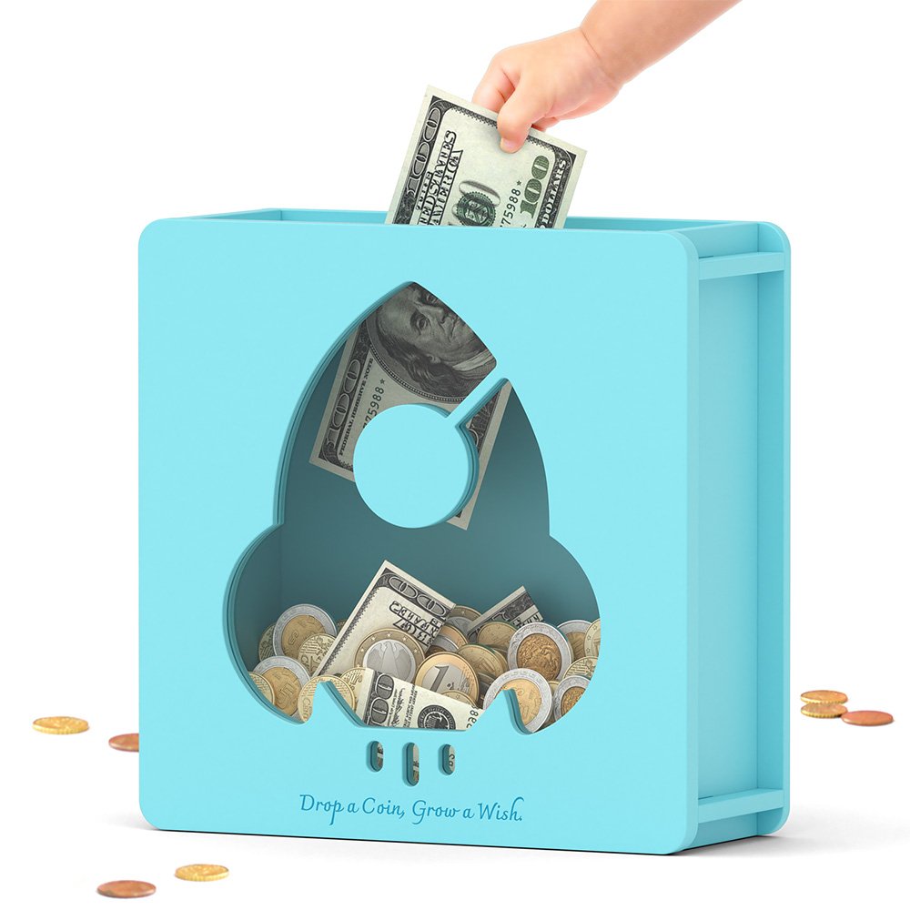 Inserting folded dollar bills into the top slot of the blue rocket shape cash savings bank, a great way for kids to save their pocket money.